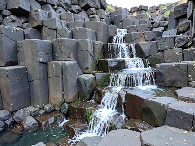 Water flowing over basalt column steps