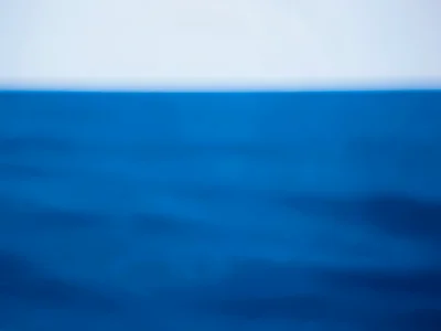 Sea surface blurred to solid blue