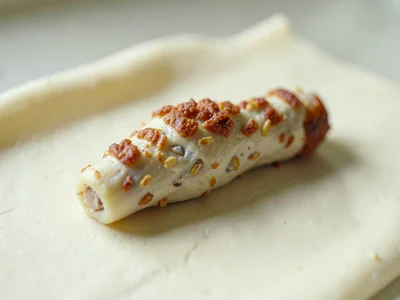 Toasted oat-cream chicken drumstick with thumb-pressed crisp marks and fingernai