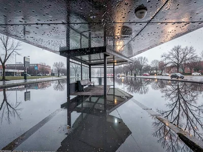 Bus shelter reflected in rain