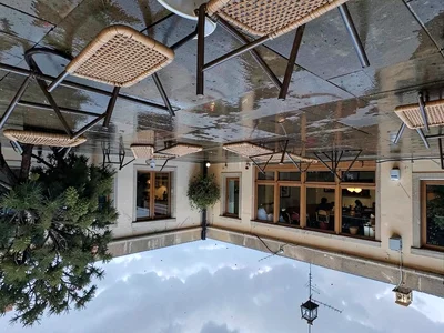 Cafe chairs reflected in wet terrace