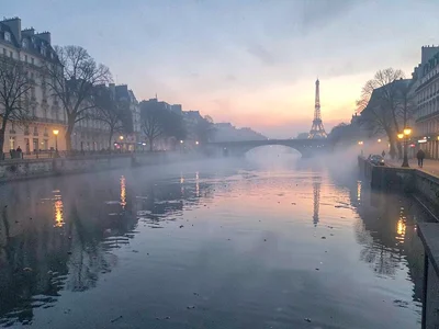 Quay lights reflecting on mist-shrouded water