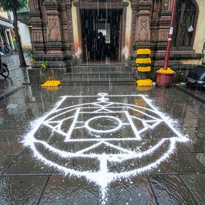 Looking down at Chennai's overlooked patterns, Monsoon rain washing away a kolam
