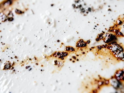 Matte white glaze with dry surface, chalk-like texture that absorbs light rather