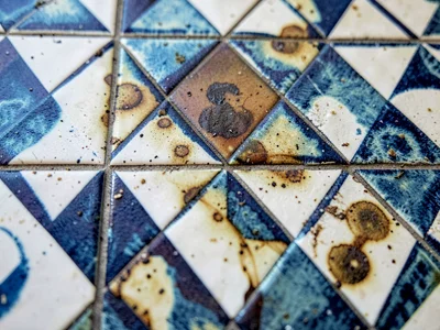 Water stain on tilework creating natural overlay
