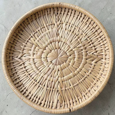 Hand-woven basket texture, palm frond material, geometric pattern, overhead shot