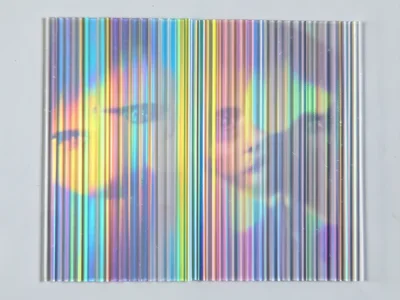 Holographic sticker surface at flat angle, single-color zone of the rainbow refl