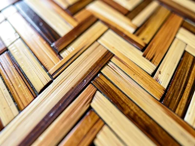 Macro close-up of a herringbone straw panel — color variation across adjacent st