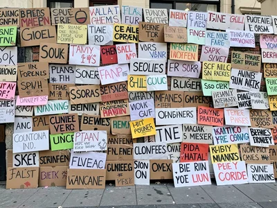 Protest signs stacked as wall of messages
