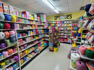Craft supplies section, yarn and glue and glitter, creative materials available 