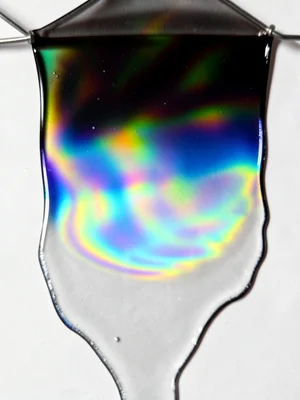 Soap film draining, thick at bottom (silver) thin at top (black), vertical gradi