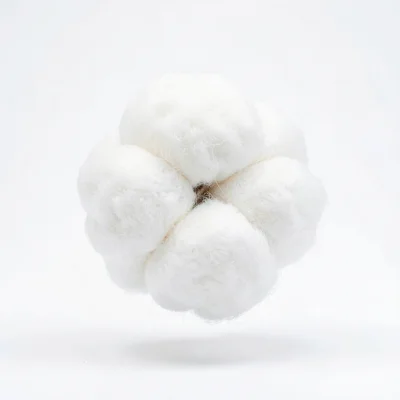 Cotton ball lit to show every fiber, floating in clinical white, more interestin