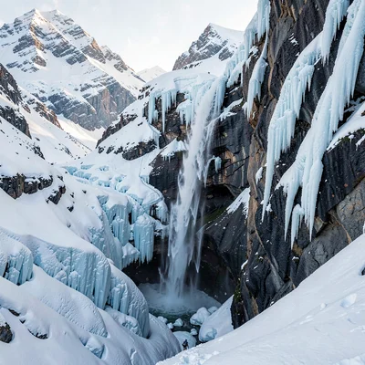 Crisp Alpine clarity, formal composition, Frozen waterfall cascading down cliff 