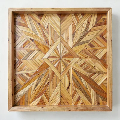 An overhead view of a straw marquetry tray with a central diamond medallion moti