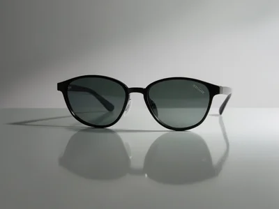 Sunglasses on a reflective surface, dramatic studio lighting, product photograph