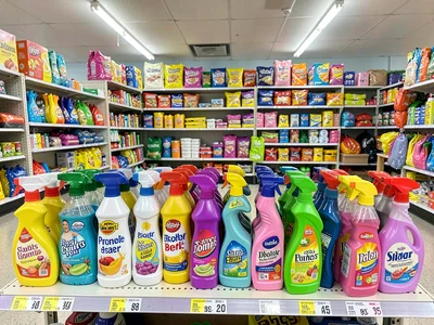 Cleaning supplies rainbow, colorful bottles lined up, promise of cleanliness in 