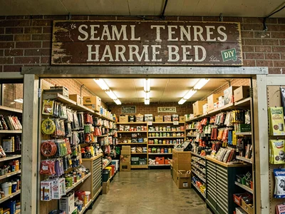 Small town hardware store exterior, hand-painted sign, been there for decades
