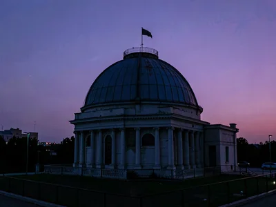 Observatory dome silhouette against violet twilight gradient