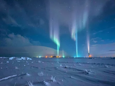 Light pillars from distant town lights in cold
