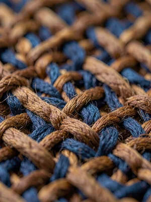 Basketweave cotton in walnut-brown shows chunky earth-tone crossings with shallo