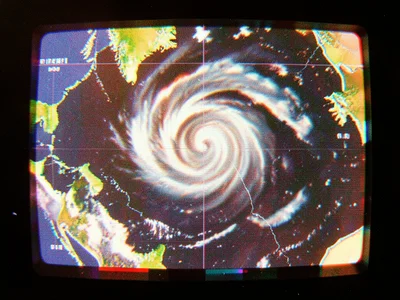 A weather map showing a hurricane, the spiral distorted by tape degradation