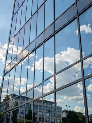 Glass facade reflecting sky