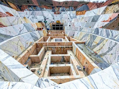 Quarry viewed from below showing massive scale of cuts