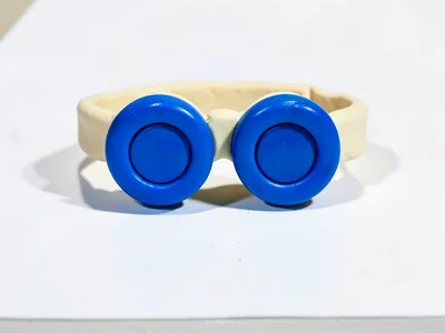 Compact chunky clay swimming goggles in primary blue with stubby cream-toned str