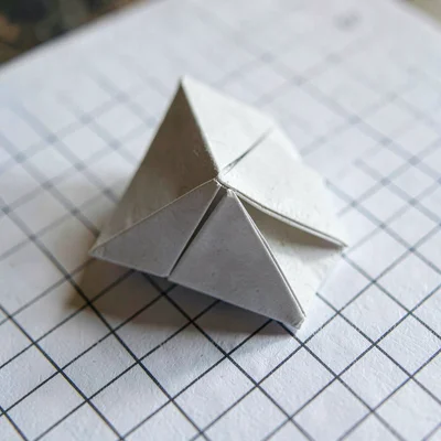 Macro of a folded origami polyhedron resting on a sheet of graph paper