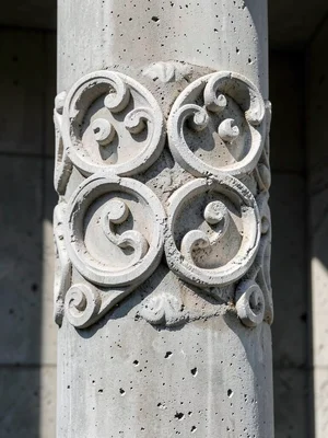 Carved plaster arabesque pattern on brutalist concrete column, light and shadow