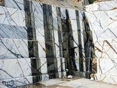 Water seeping from quarry face creating dark vertical