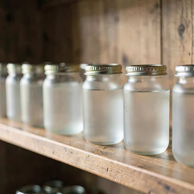 Macro of a wooden shelf with rows of frosted pints, soft natural light