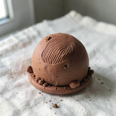 Edible terracotta truffle with thumb-pressed cocoa dust and fingernail dents aro