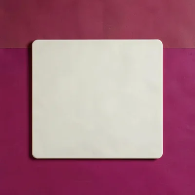 single matte-cream silicone trivet-mat top-down on a saturated raspberry backdro