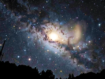 Galaxy silhouette against brighter background cluster