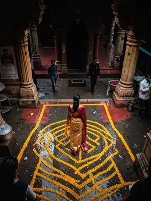 Woman entering temple with garland