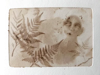 Ghost pull of a dense botanical monoprint, faint fern and leaf impressions in ex