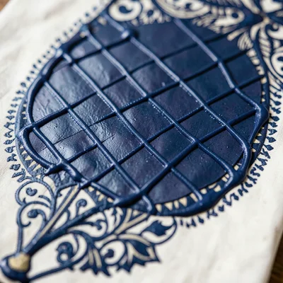 Close-up of a gringsing diamond lattice motif, wax lines fine as a pen