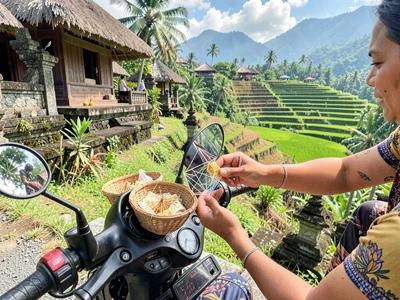 Placing canang sari on motorbike dashboard