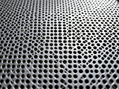 Perforated metal plate, regular grid of round holes in stainless steel, clean ge