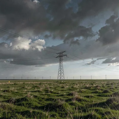 Vast horizontal landscape, extreme width composition, A single transmission towe