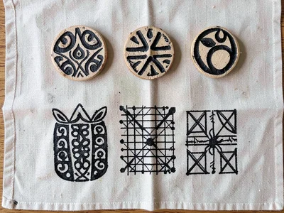 Adinkra stamp collection — six carved calabash stamps arranged by symbol shape