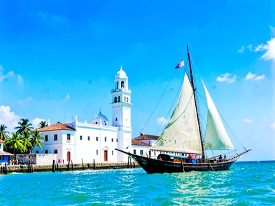 Brilliant Indian Ocean noon light in Dar es Salaam, Whitewashed mosque minaret a
