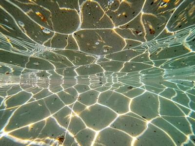 Caustic pattern reflecting back up to underside of surface