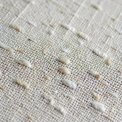 Surface macro of raw linen canvas weave with natural slubs in the fiber