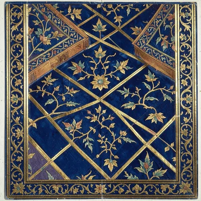 Close-up of a tiled geometric floor pattern in deep blue and gold