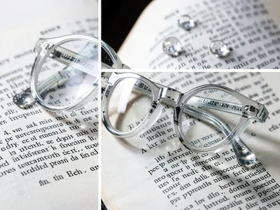Eyeglasses on open book, lenses distorting text beneath, optical prescription st