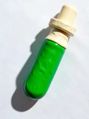 Scientific chunky clay test tube in primary green with stubby cream-toned stoppe