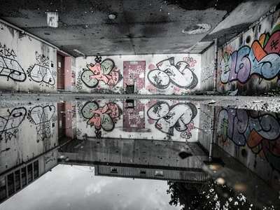 Graffiti wall reflected in puddle