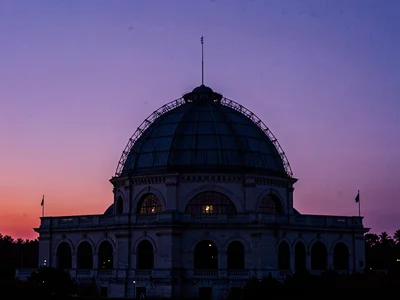 Observatory dome silhouette against violet twilight gradient
